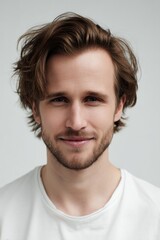Obraz premium Modern Beauty Shot of a Friendly Eurasian Man with Natural Glow and Wavy Light Brown Hair 