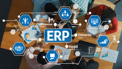 Aerial view of a team engaged in a collaborative meeting on enterprise resource planning, featuring charts and visual strategies for efficient business operations and management. Amity