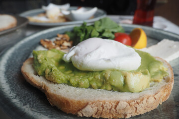 Delicious avocado toast with poached egg on a sunny morning