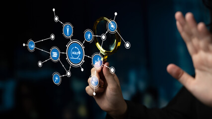 A close-up view of a hand holding a magnifying glass, highlighting various digital icons representing data and information technology in a blurred dark background. Tessel