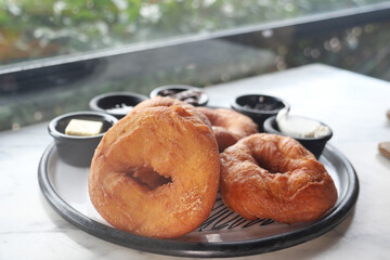 Freshly baked donuts served with toppings for breakfast