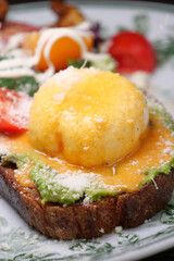 Delicious avocado toast topped with a poached egg