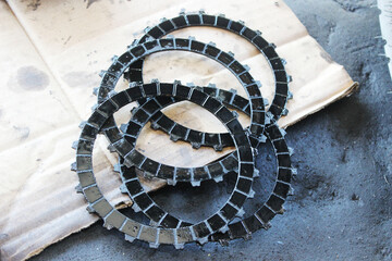 Various motorcycle clutch components laid out, including springs and gear plates.