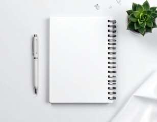 Clean, white workspace w/ plant, notebook, and pen