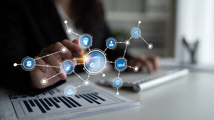 A businesswoman interacts with a high-tech interface displaying data and analysis, symbolizing modern workplace innovation, digital communication, and strategic growth. Tessel
