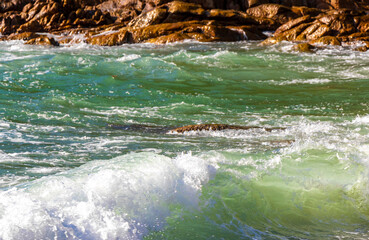 Fototapeta premium Tropical turquoise clear water waves rocks Patong Beach Phuket Thailand.