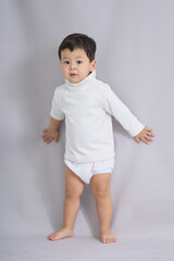 The child walks with a focused expression.