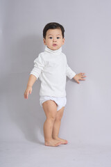 The child walks across the frame in soft light.