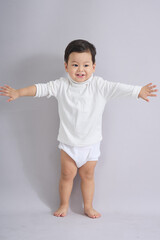 The child stands with arms outstretched.