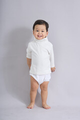 The child stands calmly facing forward.