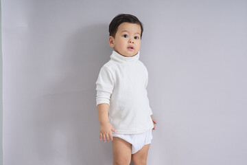 The child stands looking slightly downward.