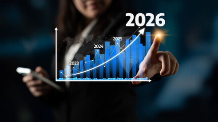 A businesswoman showcases a digital graph highlighting projected growth from 2023 to 2026. This image emphasizes trends and future planning in a corporate environment. Tessel