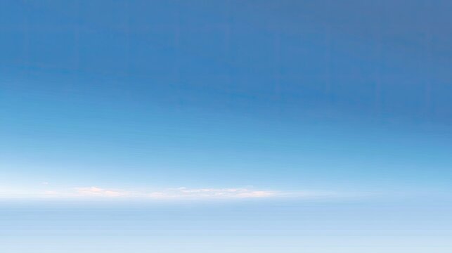 Serene Blue Sky with Soft White Clouds Over a Tranquil Horizon at Dawn, Ideal for Nature Themes and Peaceful Backgrounds in Various Projects