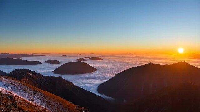 Sunrise Over Mountain Peaks with Sea Mist