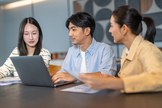 Diverse tech team meeting on software project, mentor guiding coworker on laptop, teamwork development using collaboration tools, modern technology, app design, dev training and enterprise SaaS team
