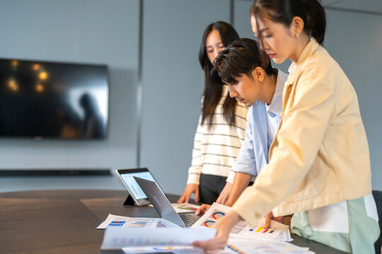 Crm software and customer management system team of asian business professionals analyzing data reports and marketing strategies, teamwork meeting improve sales service customer relationship at office