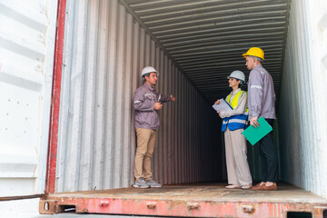 Logistics team inspecting inside empty shipping container at freight yard, Industrial workers and warehouse staff  checking container interior for cargo safety compliance