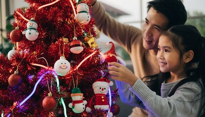 Father and Daughter Decorating Vibrant Red Holiday Christmas Tree Together