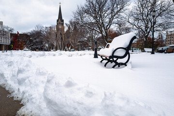 snow covered park and church