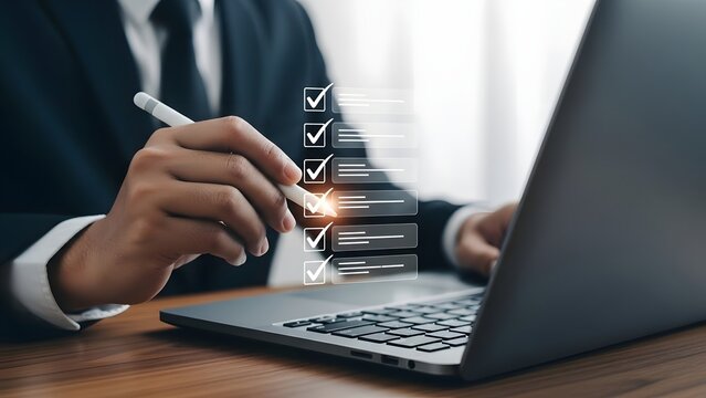 Businessman completing digital checklist on laptop for task management and productivity