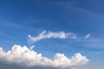 Obraz premium clear blue sky background,clouds with background, Blue sky background with tiny clouds. White fluffy clouds in the blue sky. 
