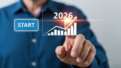 Naklejka premium A person pointing at a screen showing a graph, the word start, and the year two thousand twenty six
