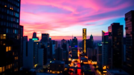 Fototapeta premium City skyline at dusk featuring blurred lights and a vibrant pink sunset.