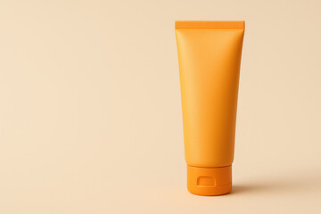 Orange sunscreen tube with realistic texture on minimal beige background, bright and clean skincare product packaging design
