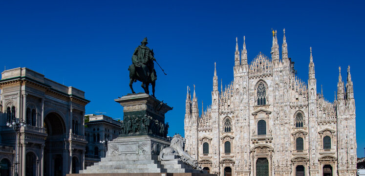 Duomo di Milano cathedral facade with blue sky background. Beautiful Gothic architecture facade of Milan Duomo Cathedral in Italy. Duomo di Milano. - Powered by Adobe