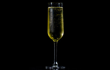 Champagne glass shining with effervescent bubbles. Sparkling wine with bubbly champagne in luxury glass. Splash of champagne for party celebration.
