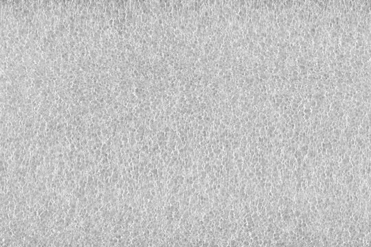 White porous synthetic polyethylene packaging foam sponge texture background.
