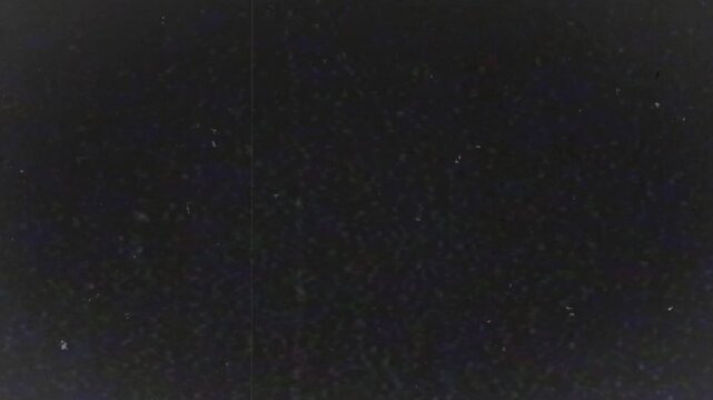 Pitch black archival loop with faint dust speckles, subtle scratches, ghostly textures, and deep moody analog film