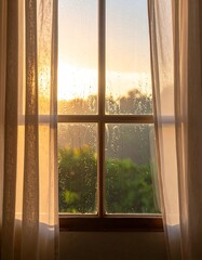 Fototapeta premium Soft light streams through a window, behind sheer curtains