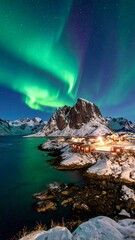 Scenic Northern Lights illuminate a village by a snowy fjord and mountains