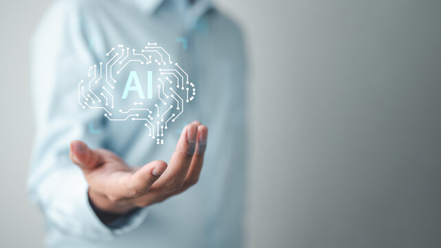 ai, automation, A concept image showing artificial intelligence represented by a digital brain icon floating above a person’s hand, symbolizing innovation and smart technology.
