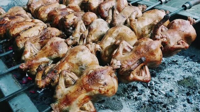 Balochi sajji chickens roasted over glowing coals in traditional style
