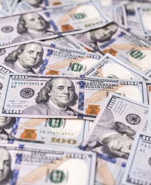Money background with 100-dollar bills. Texture of US money currency. 100 USD banknotes in focus. American hundred-dollar money backdrop. Pattern of US dollars. Money for finance concept.