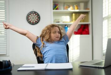 Bored kid leaning back tired of studying. Bored child waiting for study break. Bored kid sighing during long study hours. Child bored with routine study lessons.