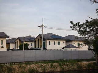 Modern Suburban Houses with Solar Panels and Air Conditioning Units