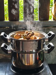 Steaming Chicken Stew Cooking in Stainless Steel Steamer Pot