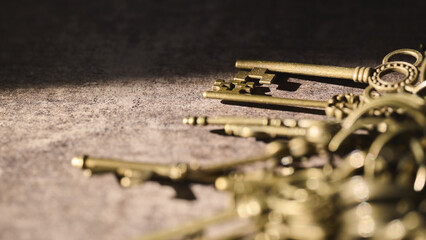 Old brass keys arranged on a textured surface