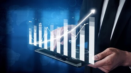 A businessman analyzes financial data on a tablet with digital charts and graphs, representing market growth and strategic planning in a modern workplace. Copula - Powered by Adobe
