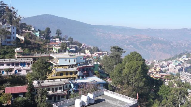 Daytime view of dense hillside houses and colorful buildings in Almora city, Uttarakhand, urban hill station landscape 4K