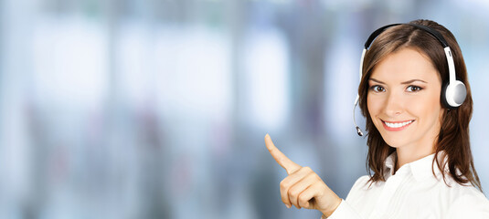 Image - happy smile customer support phone operator wear headset pointing advertise. Representative call center callcenter service. Businesswoman woman on blurred office background. Wide banner
