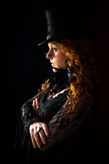 Profile portrait of a pensive-looking Victorian, Dickensian woman dressed in mourning clothes of a Top Hat with a black feather choker and dark spectacles  © DavidOsborne