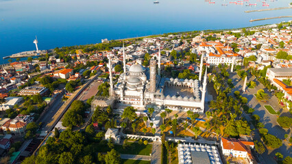 Istanbul, Turkey. Blue Mosque courtyard and minarets at Sultanahmet Square. Morning sun light on Ottoman architecture, close aerial view. Aerial View