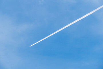 Jet plane contrail in blue sky aerial atmospheric conditions outdoor scene