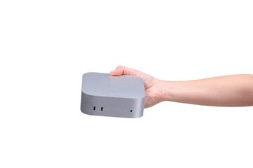 A hand holding a compact mini PC or portable computer isolated on a transparent background.