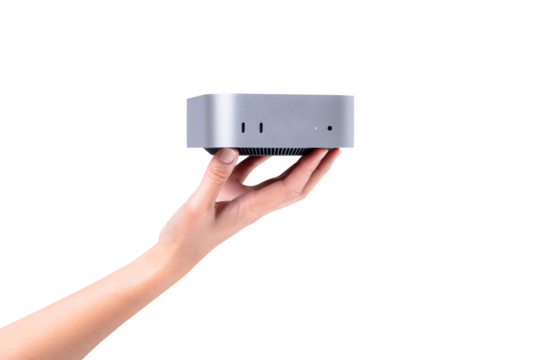 A hand holding a compact mini PC or portable computer isolated on a transparent background.