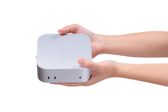 A hand holding a compact mini PC or portable computer isolated on a transparent background.